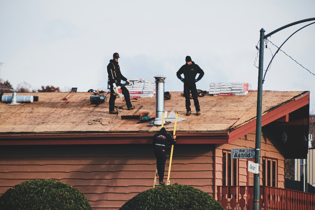 Roofing crew working on a residential roof tear-off